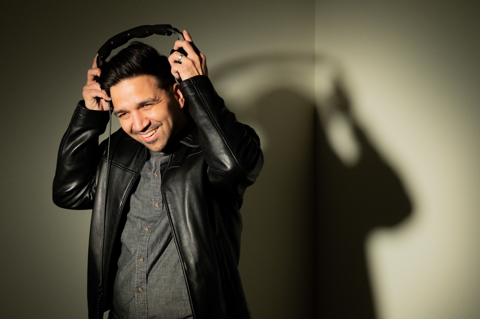 Javier Leiva, host of PRETEND, wearing studio headphones